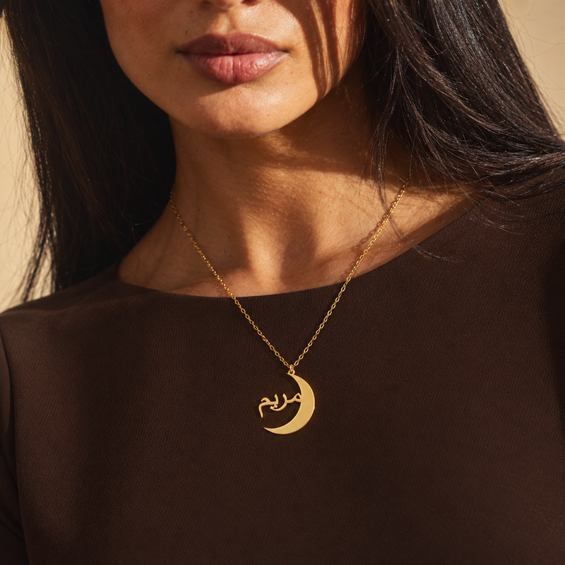 Gold crescent name necklace with a personalised Arabic name, worn
