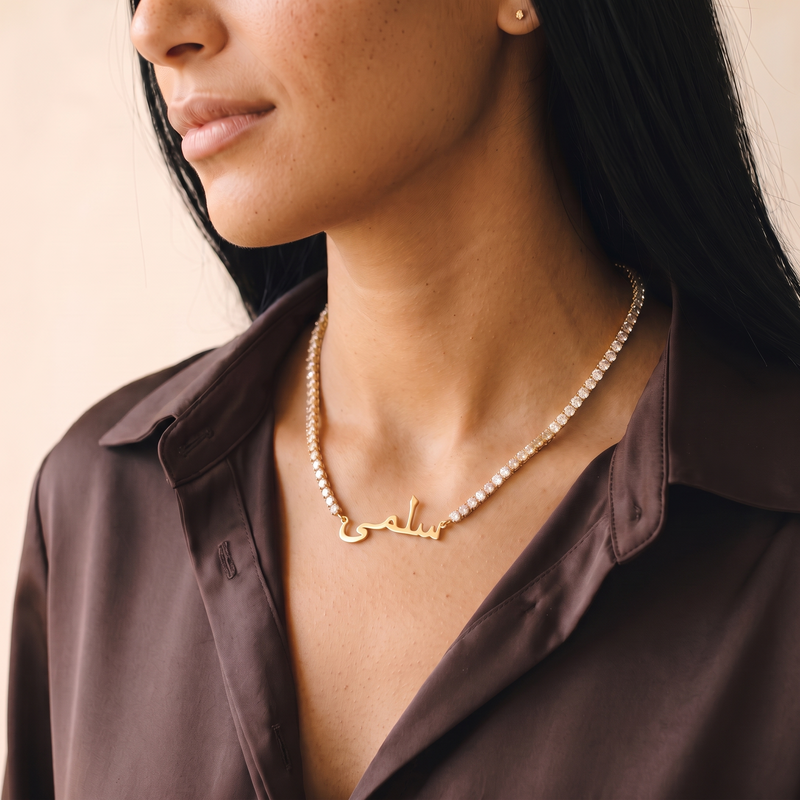 Arabic zircon name necklace worn, three-quarter view