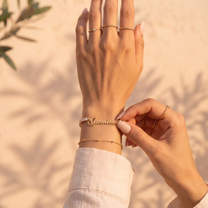 Personalized zircon name bracelet worn on the wrist, 18K gold