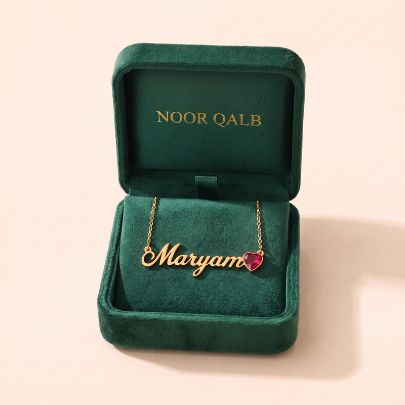 Birthstone name necklace in its Noor Qalb velvet gift box