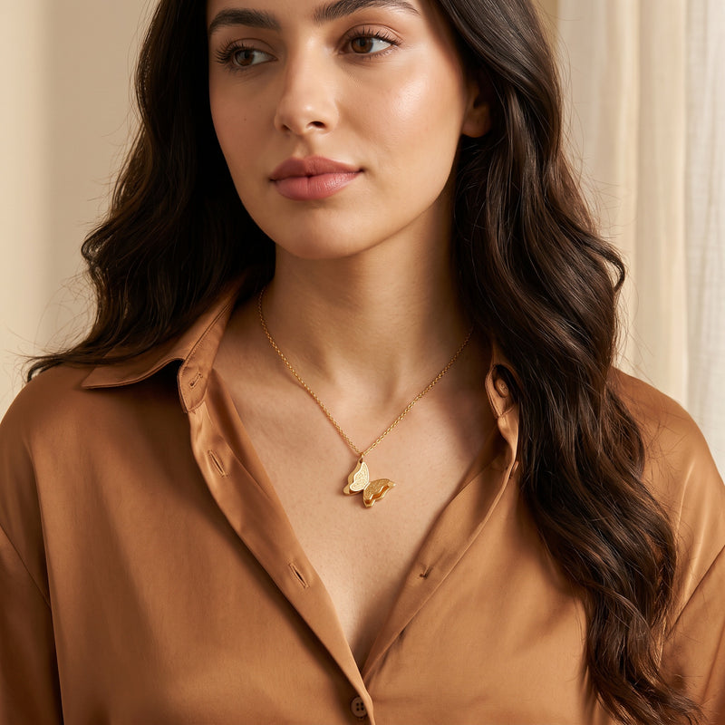 Gold Farasha butterfly necklace worn