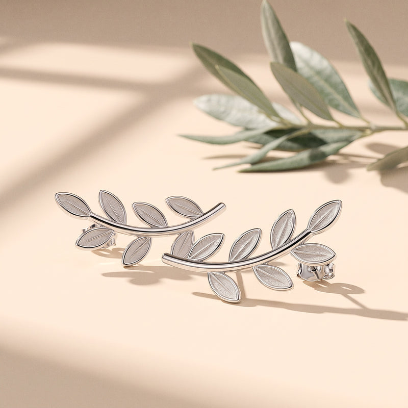 Silver olive branch ear climbers beside a sprig of olive leaves