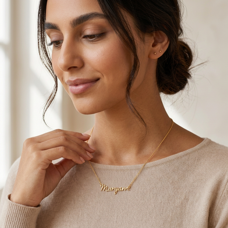 Signature name necklace worn, close detail of the script