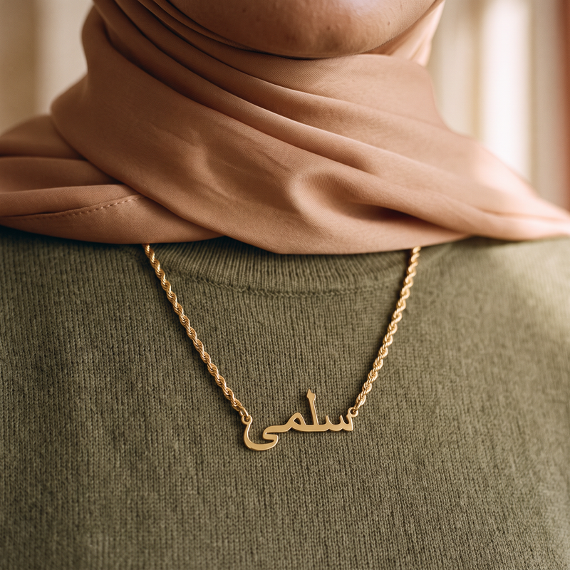 Arabic name pendant worn, close detail