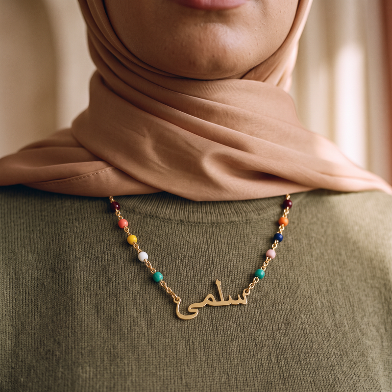 Arabic name pendant and coloured beads, close detail