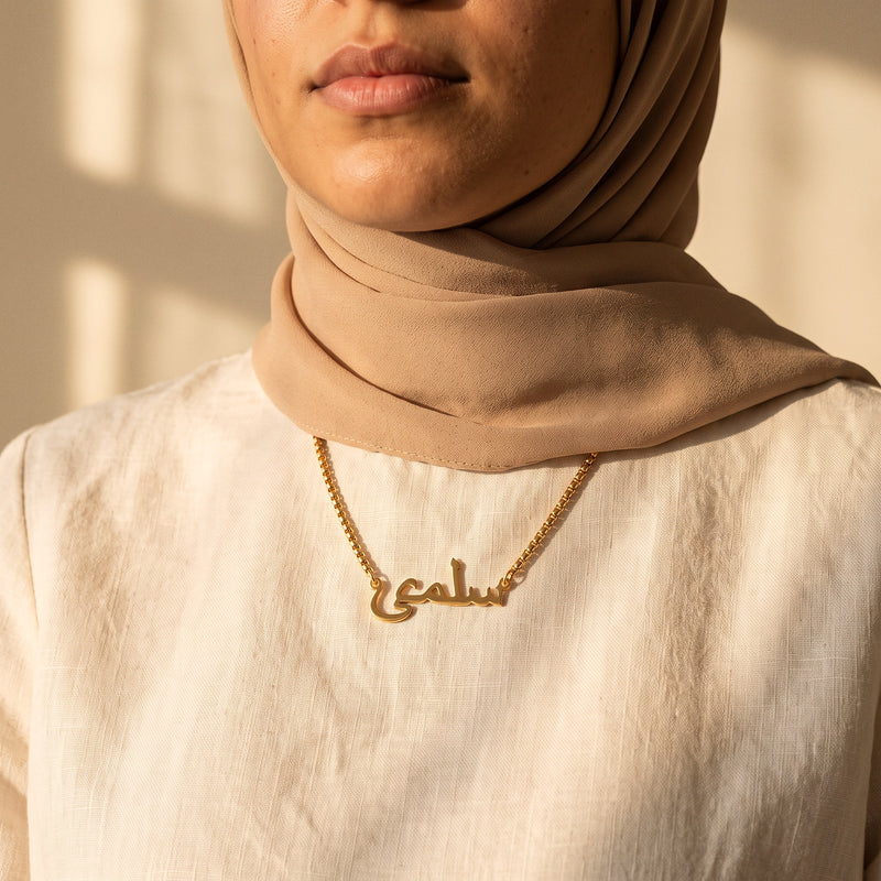 Gold Arabic name necklace on box chain, worn