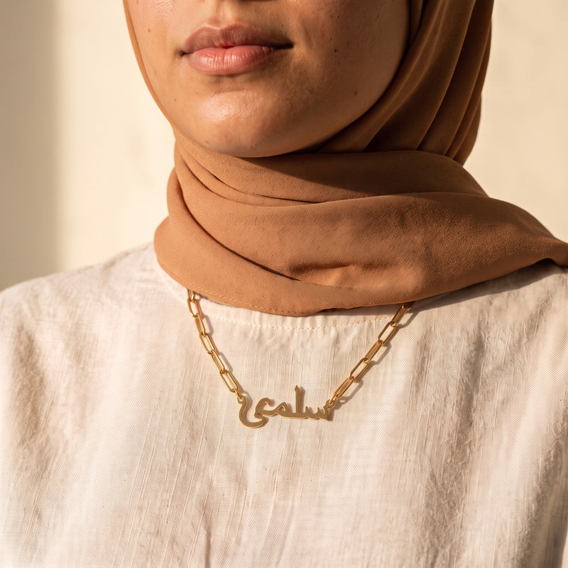 Arabic name necklace paperclip chain worn over linen