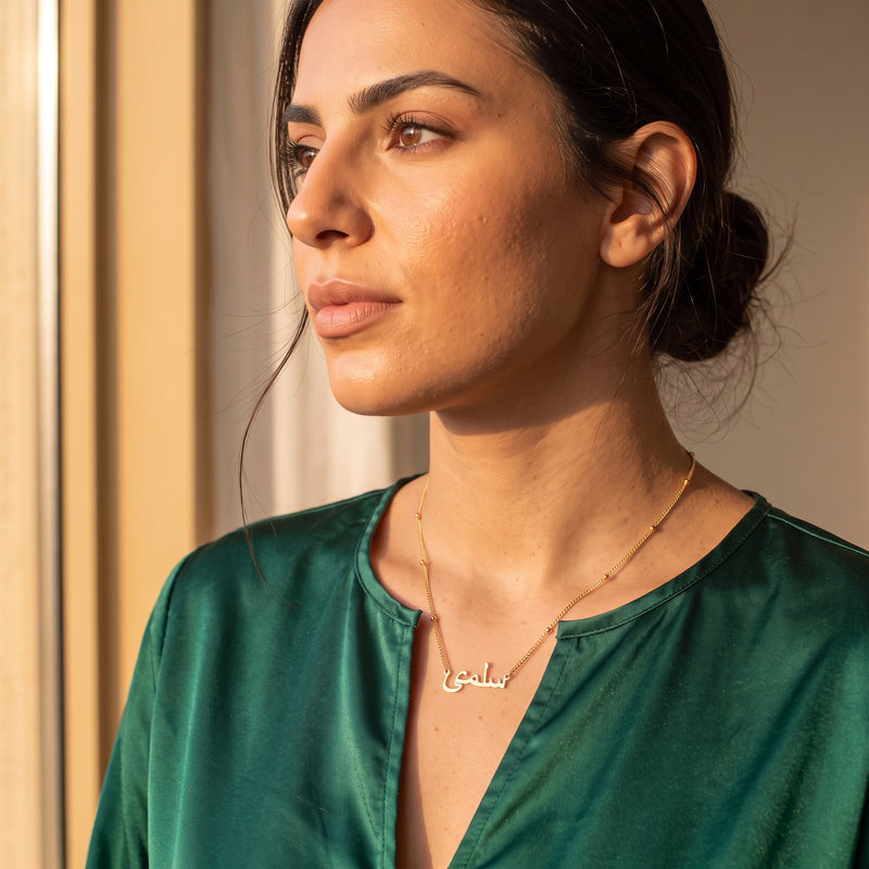 Arabic name necklace satellite chain worn, profile view