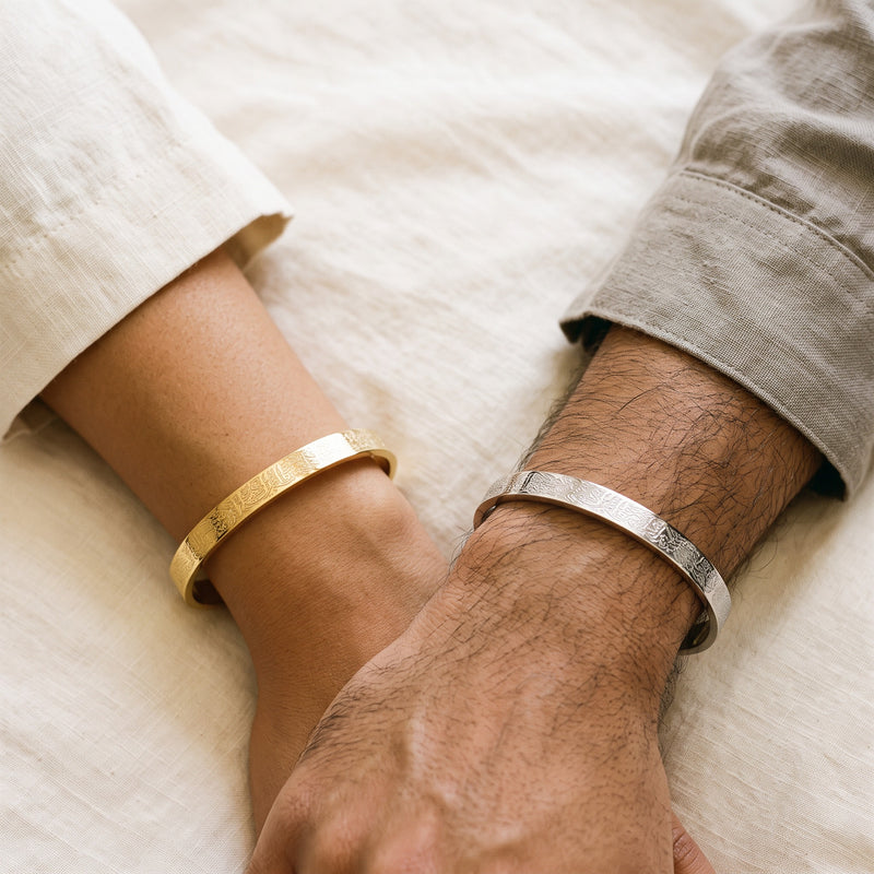 Matching Calligraphy His & Hers cuffs worn, gold and silver