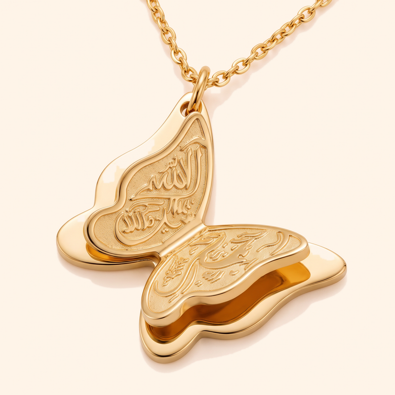 Close-up of the engraved calligraphy on the Farasha butterfly pendant
