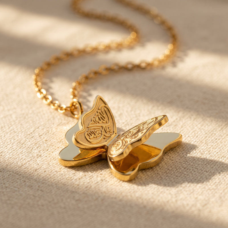 Gold Farasha butterfly necklace on linen