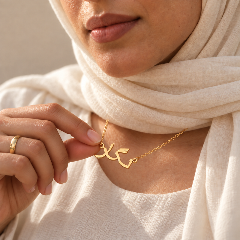 Farsi name necklace held, gold Persian calligraphy pendant