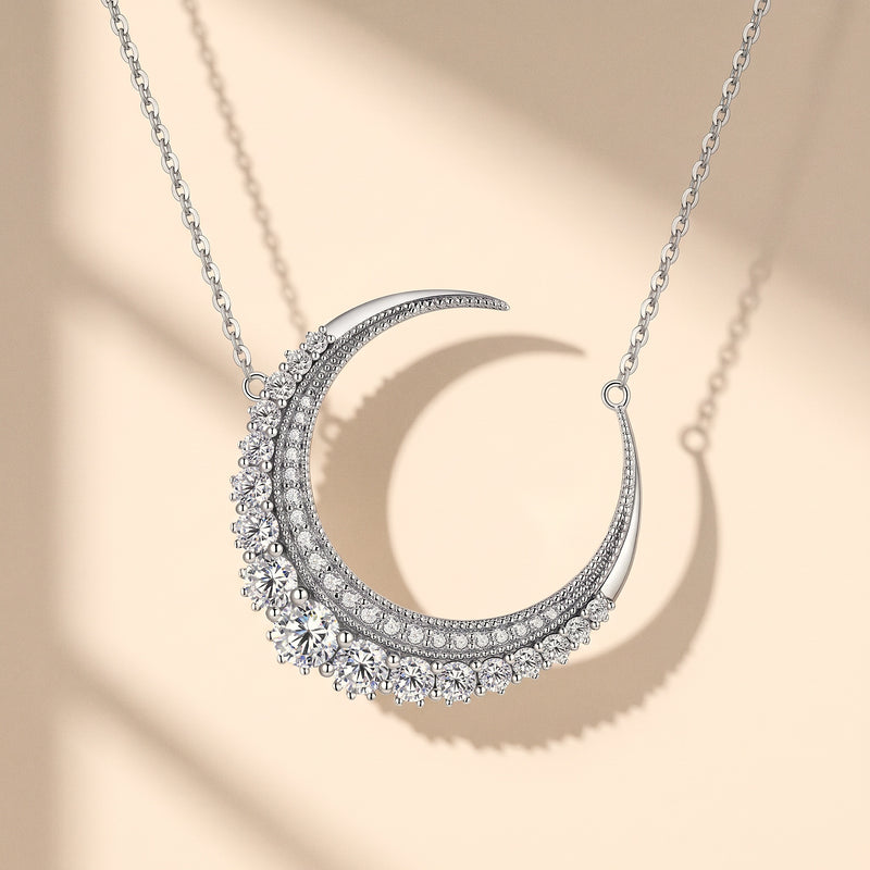Moissanite crescent moon pendant hanging on its silver chain
