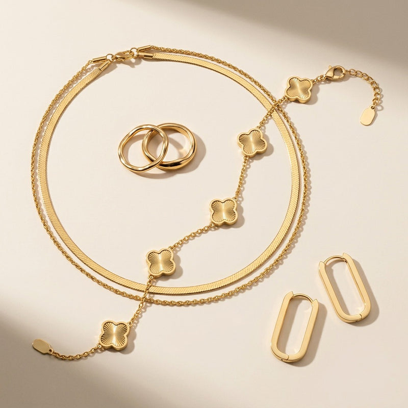 The Noor Gold Essentials - the four pieces laid out on cream