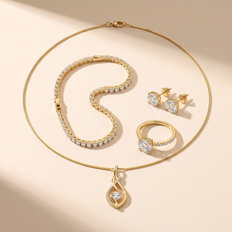 The Noor Moissanite Set - the four moissanite pieces laid out on cream
