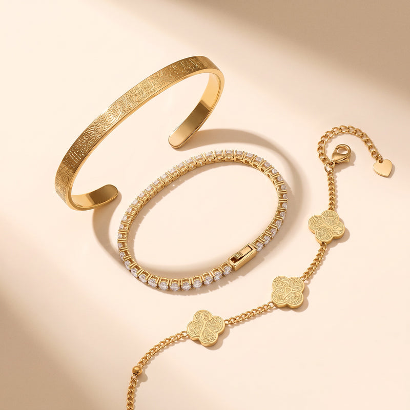 The Noor Radiance Stack - three gold bracelets laid out on cream