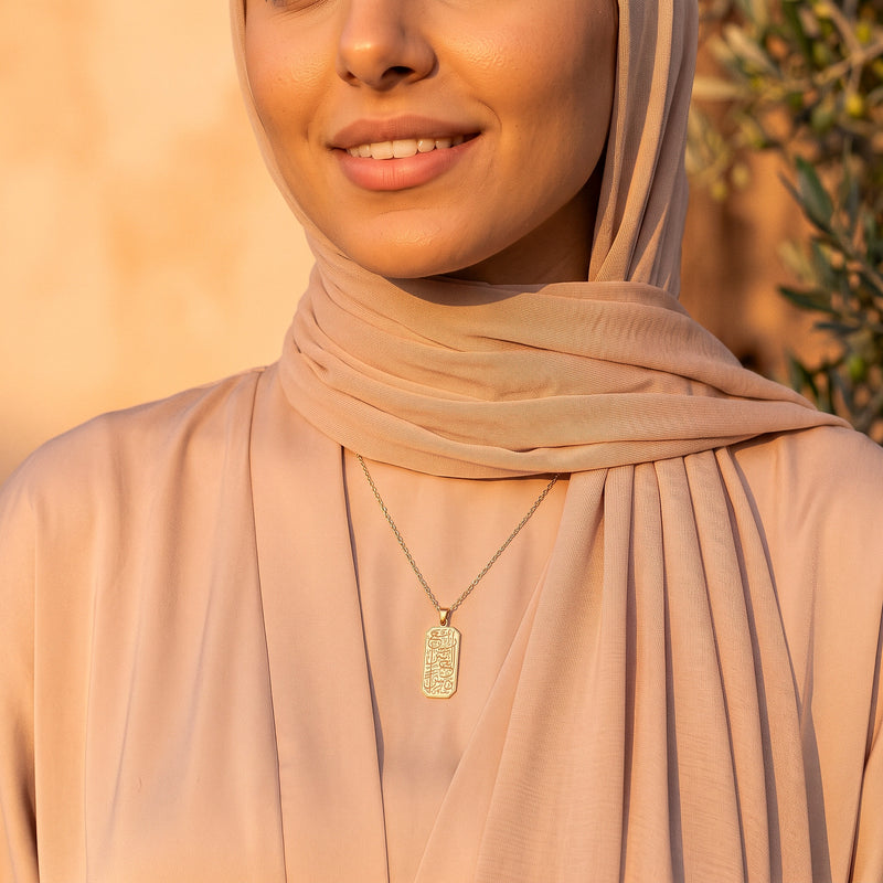 Gold Yusra Pendant worn with a hijab