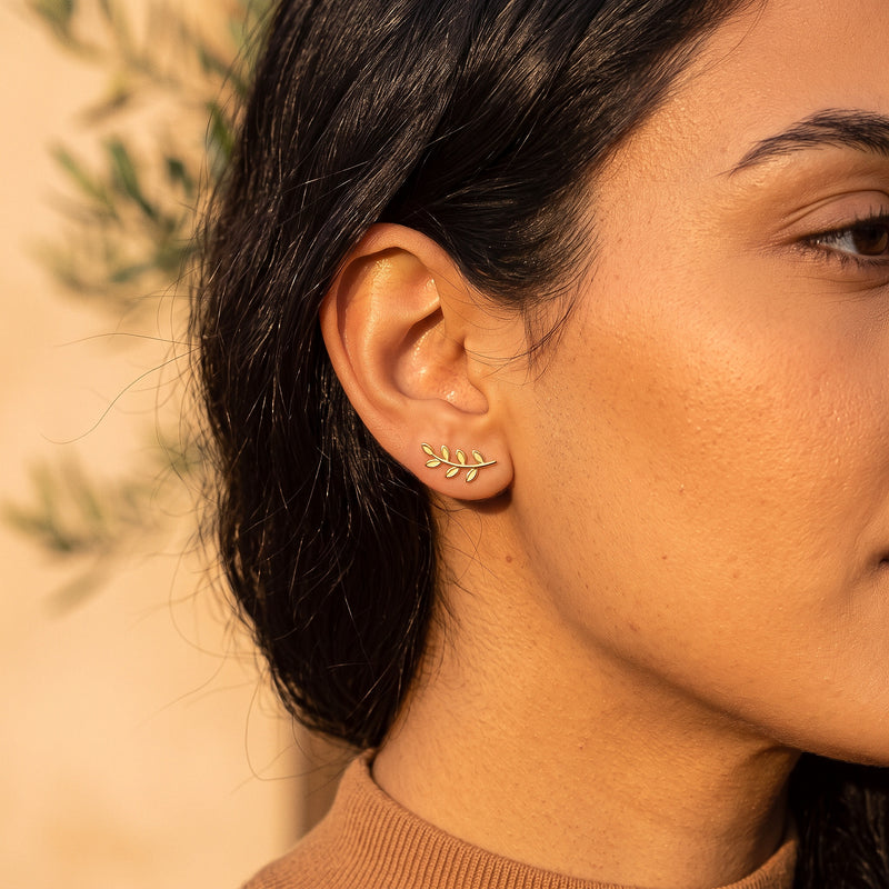 Olive Branch Earring worn on the ear - gold olive branch earring